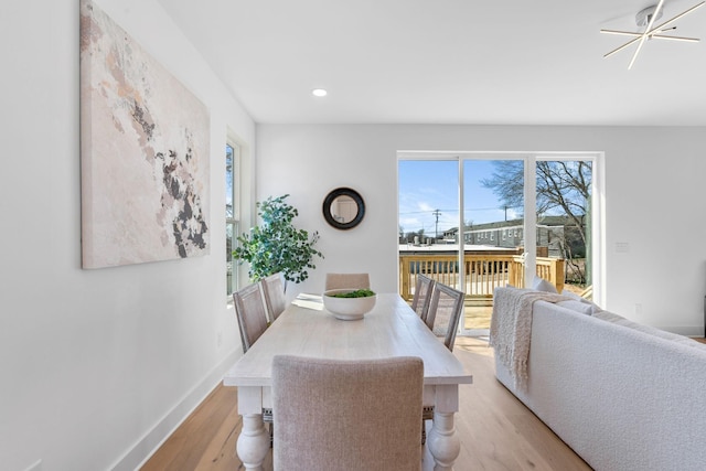 dining area featuring light wood-style floors, healthy amount of natural light, recessed lighting, and baseboards