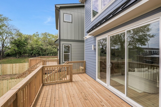 wooden terrace featuring fence