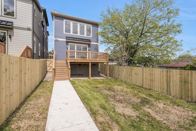 back of property with a deck and stairs
