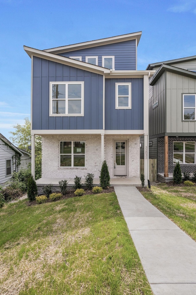 view of front of property featuring board and batten siding and a front lawn