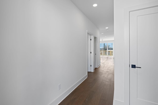 hall with dark wood-style floors, recessed lighting, and baseboards