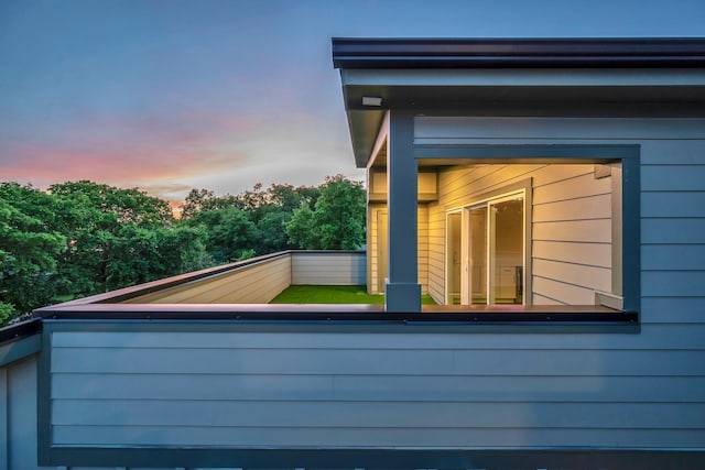 property exterior at dusk with a balcony