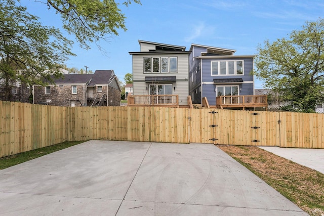 rear view of property with a gate