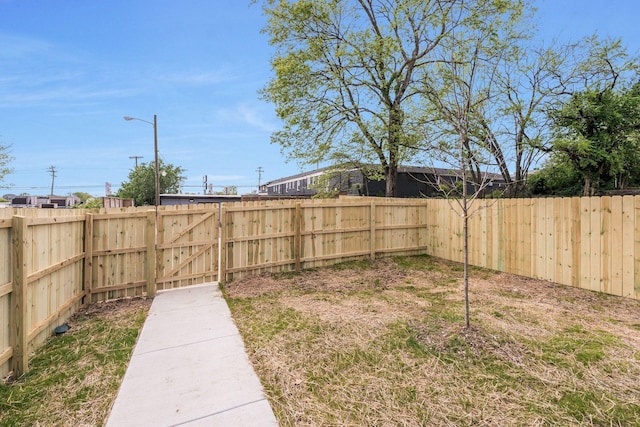 fenced backyard with a gate