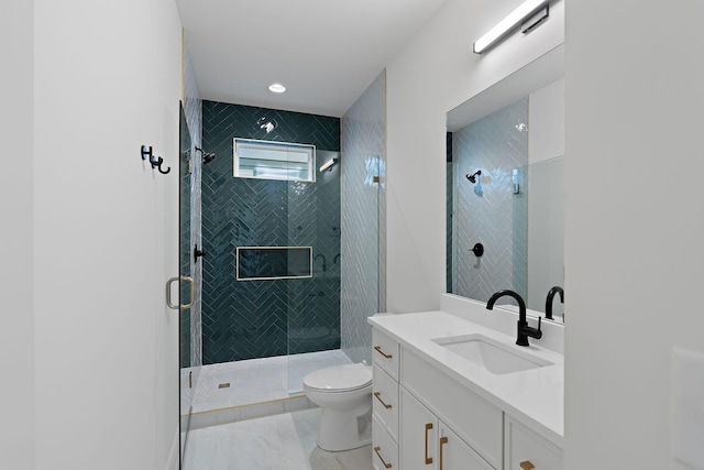 bathroom featuring a stall shower, vanity, toilet, and marble finish flooring