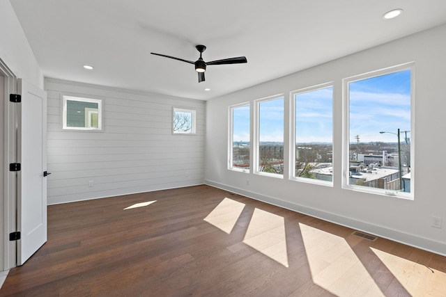 spare room with dark wood-style flooring, baseboards, a ceiling fan, and recessed lighting