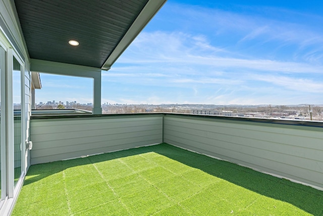 view of yard featuring a balcony and a city view