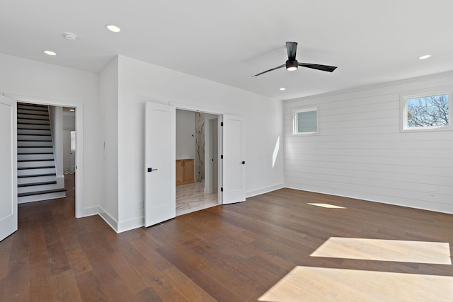 unfurnished bedroom with wood finished floors, baseboards, recessed lighting, a ceiling fan, and connected bathroom