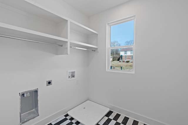 washroom with hookup for a washing machine, electric dryer hookup, tile patterned floors, and baseboards