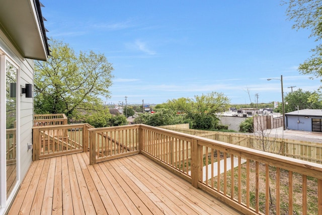 wooden terrace with a fenced backyard
