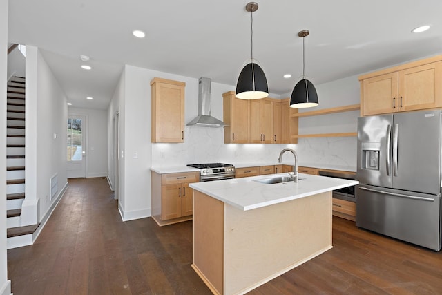kitchen with stainless steel appliances, wall chimney exhaust hood, light brown cabinetry, a sink, and recessed lighting