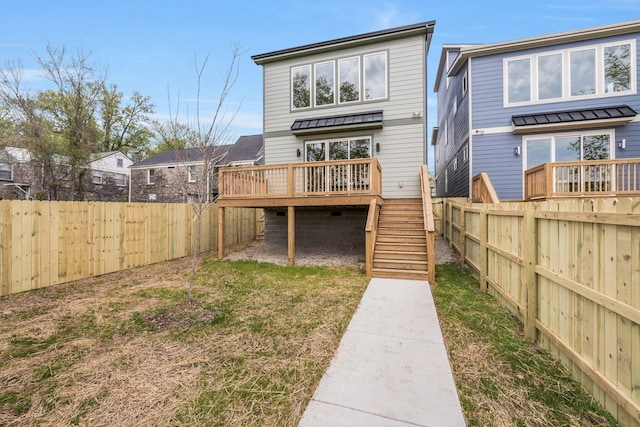 rear view of property with a deck and stairway