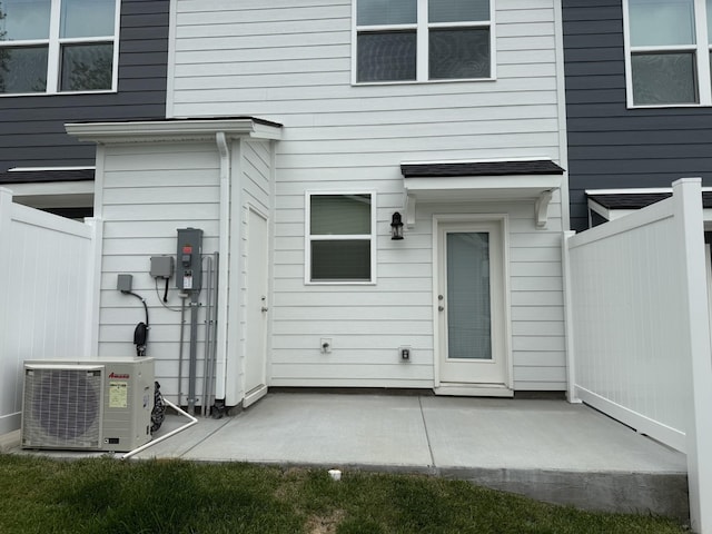 back of property with ac unit, a patio, and fence