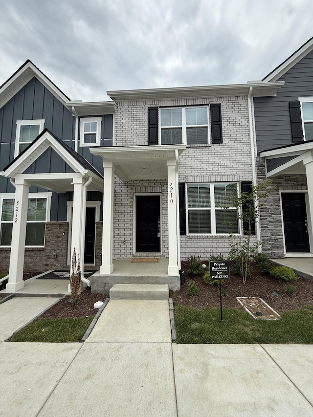 townhome / multi-family property featuring brick siding
