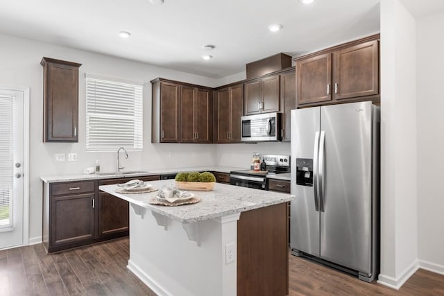5210 Gladecress Ln, Hermitage, TN 37076 - kitchen with appliances with stainless steel finishes, a sink, dark brown cabinetry, dark wood-style floors, and a kitchen island