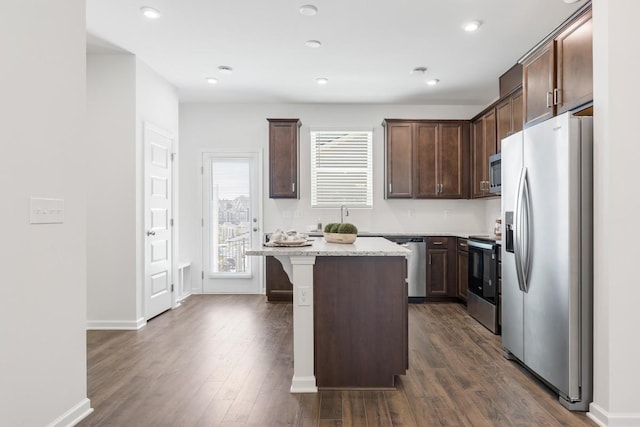 5210 Gladecress Ln, Hermitage, TN 37076 - kitchen with appliances with stainless steel finishes, a kitchen island, dark wood-type flooring, dark brown cabinetry, and recessed lighting
