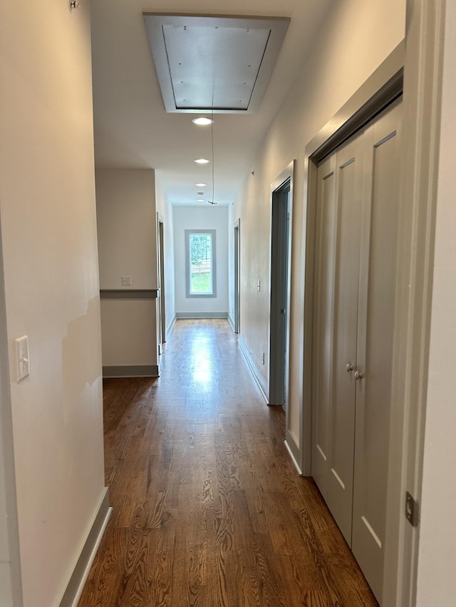 hall featuring attic access, dark wood-style floors, baseboards, and recessed lighting