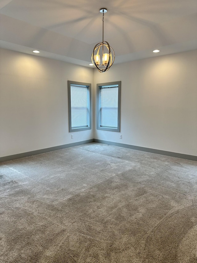 unfurnished room featuring carpet flooring, a chandelier, recessed lighting, and baseboards