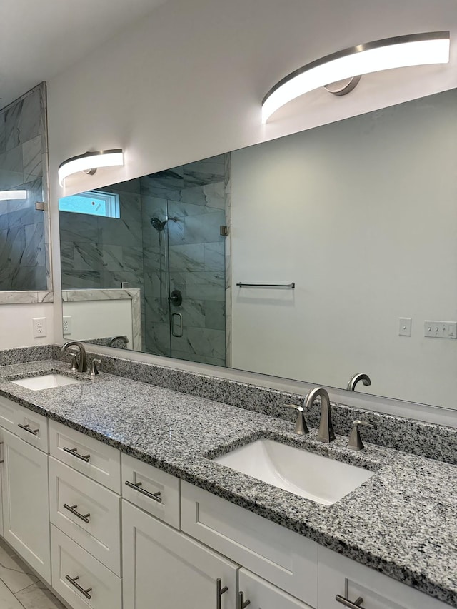 full bathroom featuring a marble finish shower and double vanity