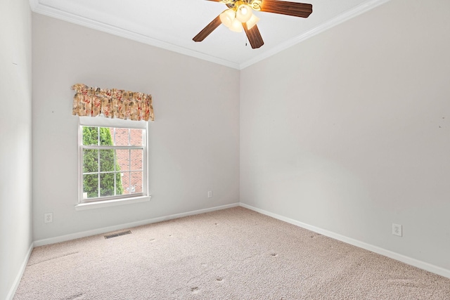 carpeted empty room with ornamental molding, baseboards, and a ceiling fan