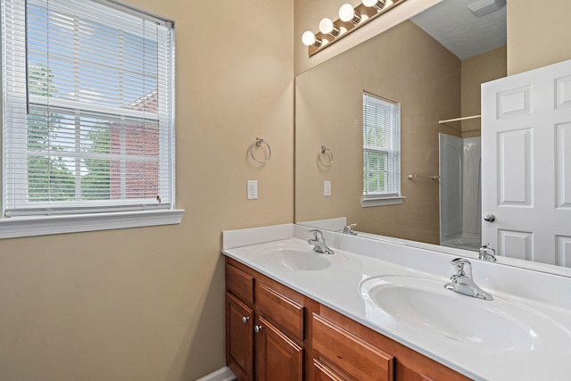 bathroom with double vanity and shower / bathtub combination