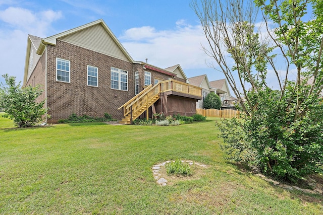 rear view of property with brick siding, stairs, and a wooden deck