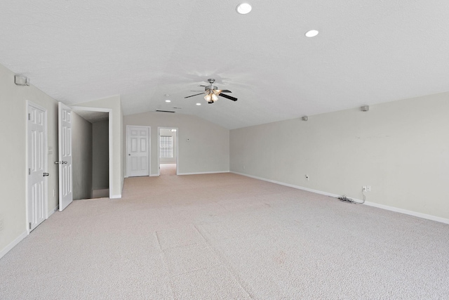 unfurnished living room featuring vaulted ceiling, a ceiling fan, baseboards, light colored carpet, and recessed lighting