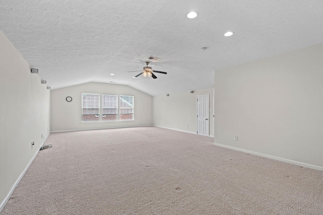 carpeted spare room with a textured ceiling, baseboards, lofted ceiling, ceiling fan, and recessed lighting