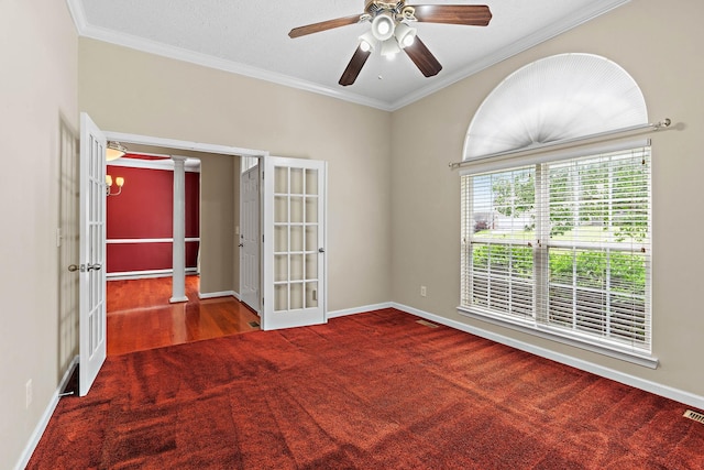 spare room featuring french doors, carpet floors, crown molding, ceiling fan, and baseboards