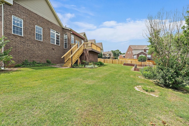 view of yard with stairway and a wooden deck
