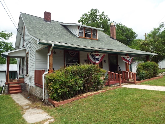 165 E Main St, Alexandria, TN 37012 - bungalow-style house featuring covered porch, a chimney, a front yard, and a shingled roof