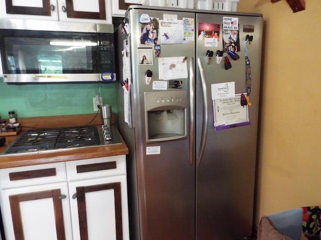 165 E Main St, Alexandria, TN 37012 - kitchen with stainless steel appliances and white cabinetry
