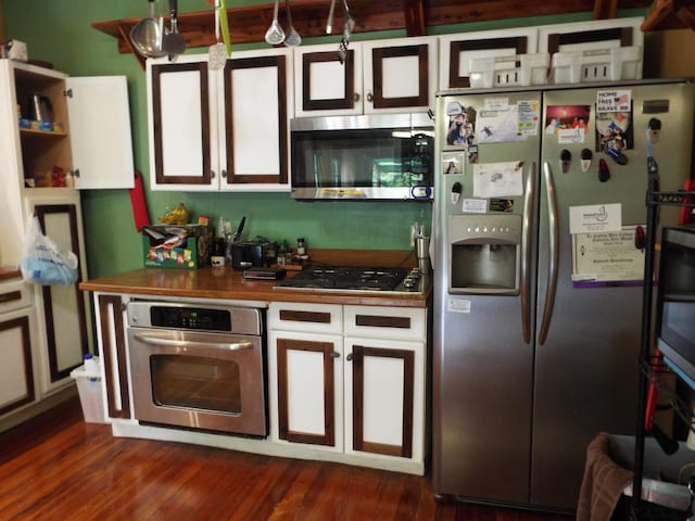 165 E Main St, Alexandria, TN 37012 - kitchen featuring appliances with stainless steel finishes, dark wood-type flooring, white cabinets, and dark countertops