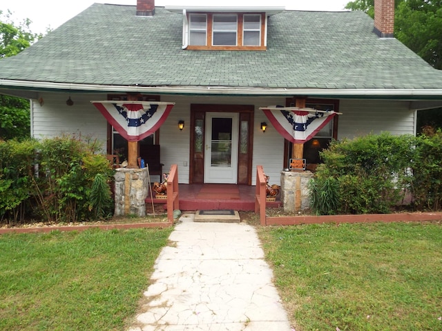 165 E Main St, Alexandria, TN 37012 - view of front of house with a chimney, covered porch, a front lawn, and roof with shingles
