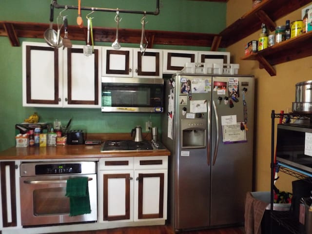 165 E Main St, Alexandria, TN 37012 - kitchen featuring stainless steel appliances, white cabinetry, and dark countertops