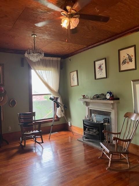 165 E Main St, Alexandria, TN 37012 - living area featuring wood ceiling, a wood stove, ornamental molding, wood finished floors, and a ceiling fan