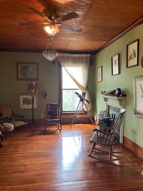 165 E Main St, Alexandria, TN 37012 - sitting room with wood finished floors, a ceiling fan, wooden ceiling, crown molding, and a fireplace