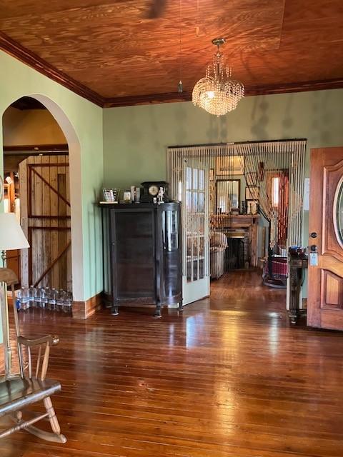 165 E Main St, Alexandria, TN 37012 - living room featuring arched walkways, ornamental molding, wood-type flooring, wooden ceiling, and a chandelier