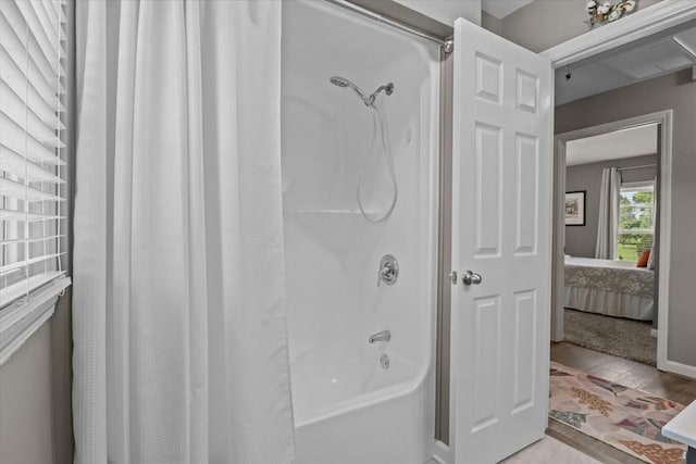 1209 Corlew Dr, Burns, TN 37029 - bathroom with shower / bath combo, connected bathroom, and wood finished floors