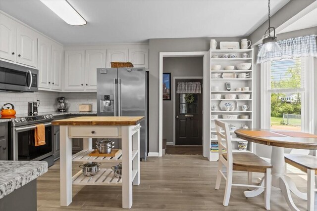 1209 Corlew Dr, Burns, TN 37029 - kitchen featuring stainless steel appliances, butcher block countertops, white cabinetry, open shelves, and tasteful backsplash