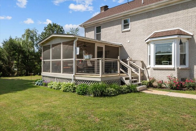 1209 Corlew Dr, Burns, TN 37029 - rear view of property with brick siding, a sunroom, a yard, a chimney, and a deck