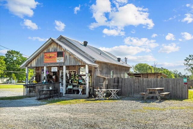 1209 Corlew Dr, Burns, TN 37029 - view of front of property with fence and board and batten siding