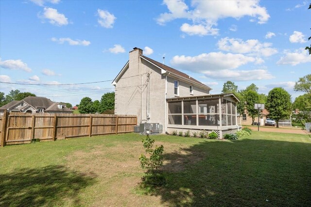 1209 Corlew Dr, Burns, TN 37029 - rear view of house with a sunroom, a chimney, and central air condition unit