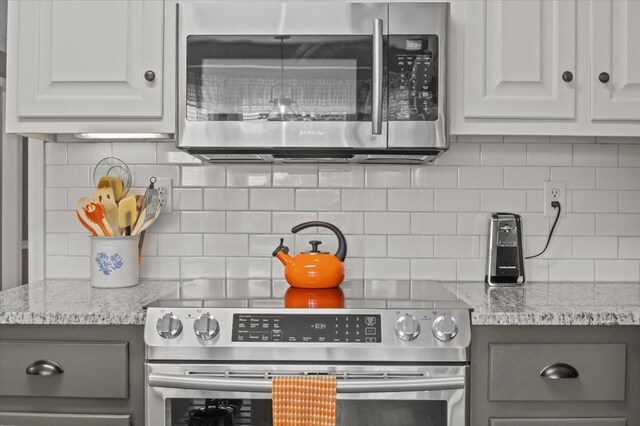1209 Corlew Dr, Burns, TN 37029 - kitchen featuring stainless steel appliances, tasteful backsplash, and light stone countertops