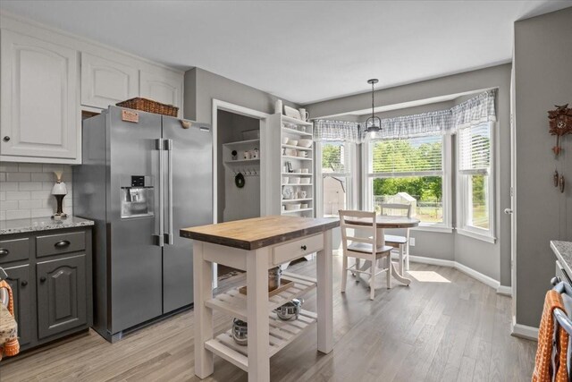 1209 Corlew Dr, Burns, TN 37029 - kitchen featuring high end fridge, baseboards, light wood-type flooring, and backsplash
