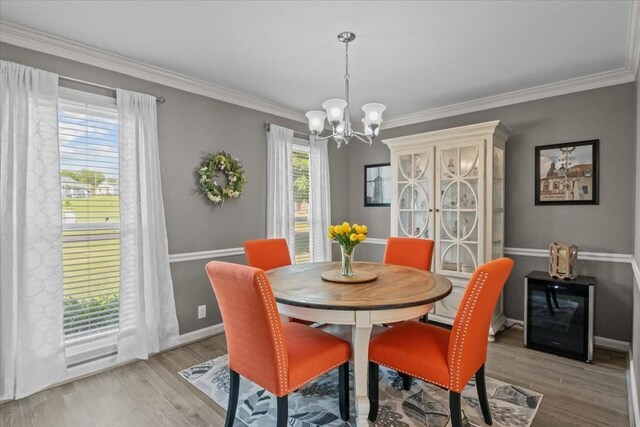1209 Corlew Dr, Burns, TN 37029 - dining space with a chandelier, wood finished floors, crown molding, and baseboards