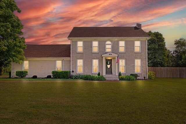 1209 Corlew Dr, Burns, TN 37029 - colonial-style house featuring a chimney and brick siding