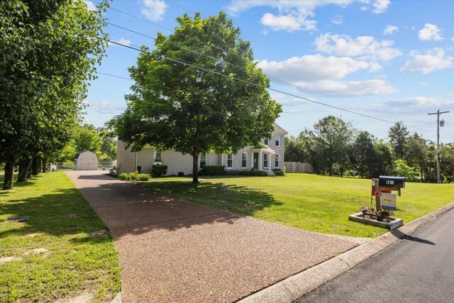 1209 Corlew Dr, Burns, TN 37029 - view of front facade featuring a front yard