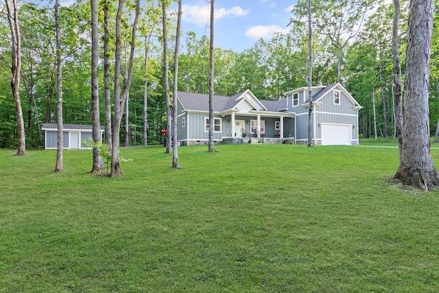 120 Destineys Way, Gruetli Laager, TN 37339 - view of front facade featuring board and batten siding, covered porch, an attached garage, and a front yard
