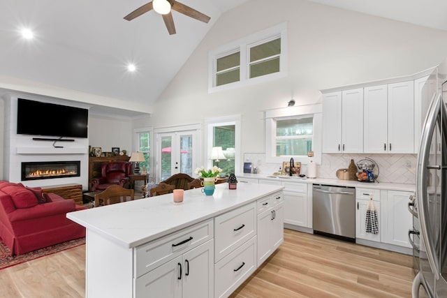 120 Destineys Way, Gruetli Laager, TN 37339 - kitchen featuring appliances with stainless steel finishes, a sink, open floor plan, high vaulted ceiling, and a kitchen island